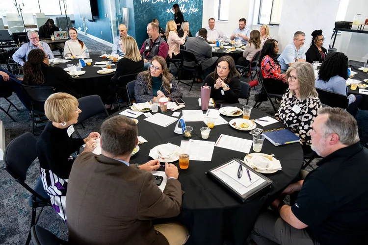 Association executives gathered around a boardroom table during a strategic planning session