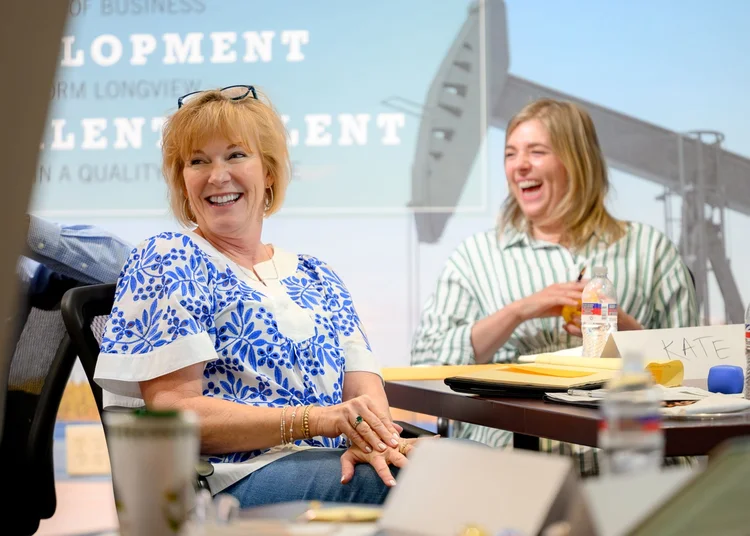 Members engaged and laughing during a Clayton Rose Group session